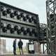 photo of two people in front of big carbon capture machine